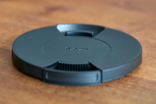 Lens cap for lenses of Japanese manufacturer Sigma on a table