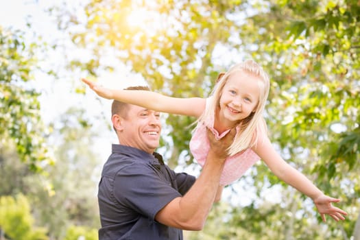 Young Caucasian Father and Daughter Having Fun At The Park.