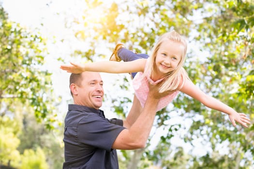 Young Caucasian Father and Daughter Having Fun At The Park.