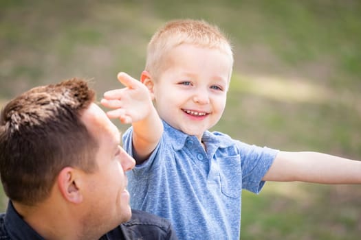 Young Caucasian Father and Son Having Fun At The Park.