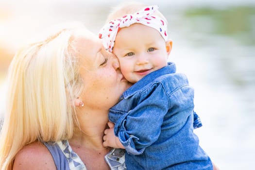 Young Caucasian Mother and Daughter At The Park.
