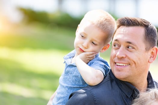 Young Caucasian Father and Son Having Fun At The Park.