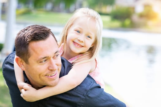 Young Caucasian Father and Daughter Having Fun At The Park.