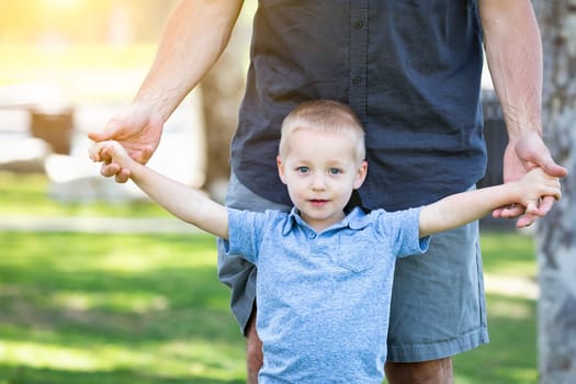 Young Caucasian Father and Son Having Fun At The Park.