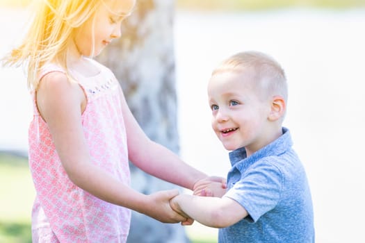 Young Brother and Sister Playing At The Park Togther.