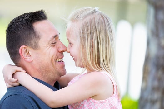 Young Caucasian Father and Daughter Having Fun At The Park.
