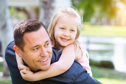 Young Caucasian Father and Daughter Having Fun At The Park.