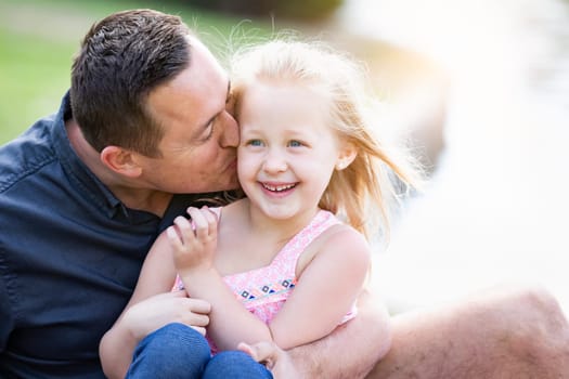 Young Caucasian Father and Daughter Having Fun At The Park.
