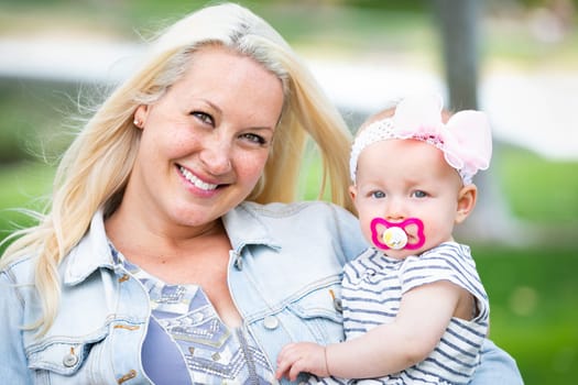 Young Caucasian Mother and Daughter At The Park.