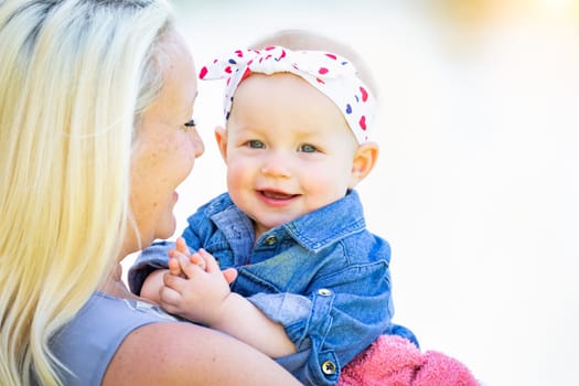 Young Caucasian Mother and Daughter At The Park.