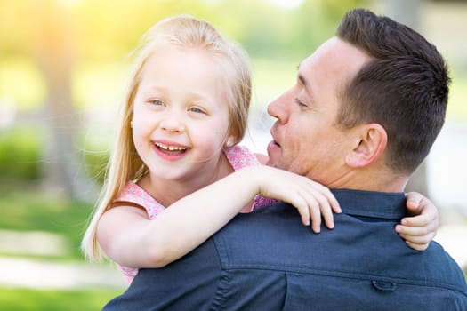 Young Caucasian Father and Daughter Having Fun At The Park.