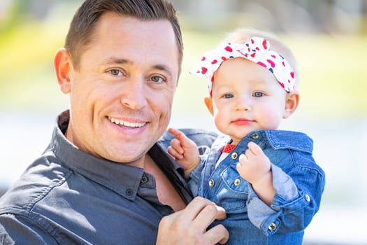 Young Caucasian Father and Baby Girl At The Park.