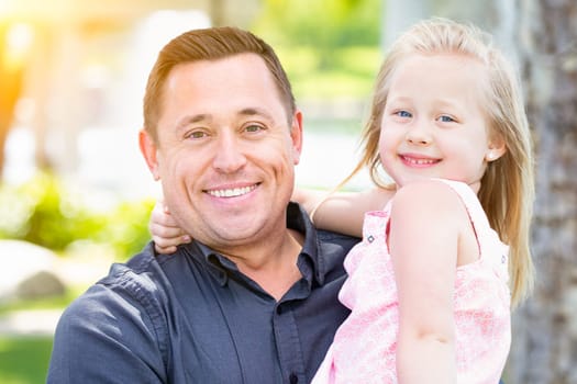Young Caucasian Father and Daughter Having Fun At The Park.