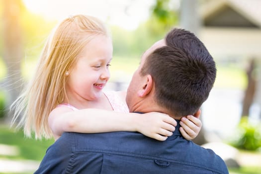 Young Caucasian Father and Daughter Having Fun At The Park.