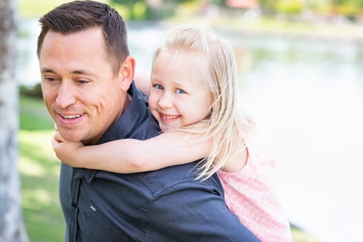 Young Caucasian Father and Daughter Having Fun At The Park.