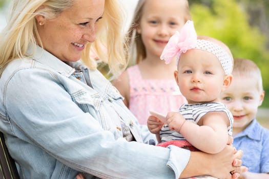 Young Caucasian Mother and Children At The Park.