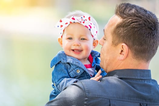 Young Caucasian Father and Baby Girl At The Park.
