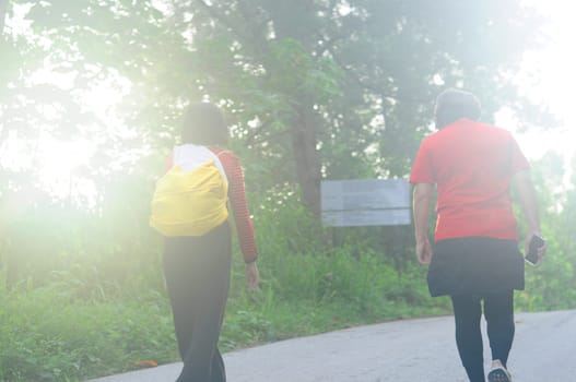 Vintage soft focus of an asian woman traveler with backpack walking in forest.Adventure, travel people concept...