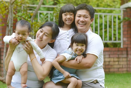 Portrait of happy asian family playing In garden.Concept of family relaxation.