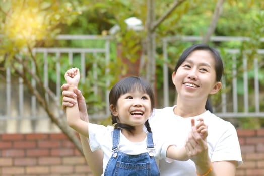 Enjoying time together.Lifestyle portrait asian mother and daughter in happines at the outside of garden park.