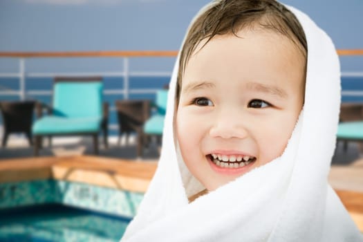 Happy Cute Mixed Race Chinese and Caucasian Boy On Cruise Ship Wrapped In A Towel.