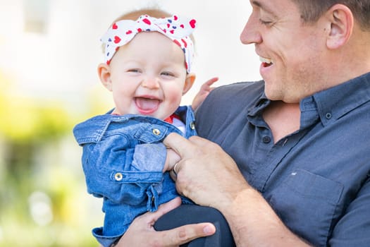 Young Caucasian Father and Baby Girl At The Park.