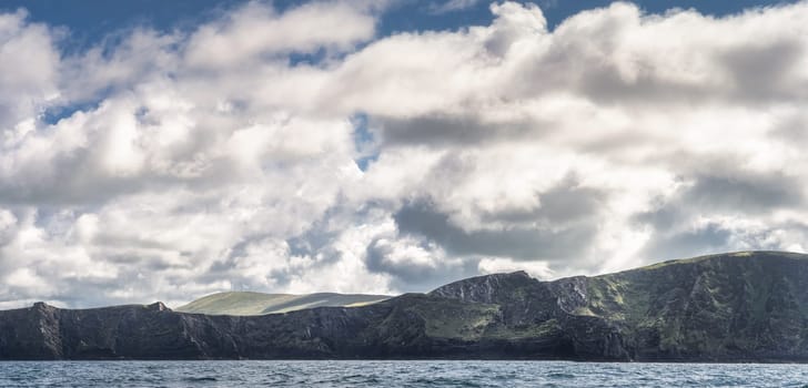 Panorama with beautiful, rough Irish coastline, Kerry Cliffs, seen from boat on Atlantic Ocean, Portmagee, Iveragh Peninsula, Ring of Kerry, Ireland