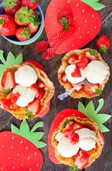Vanilla ice cream with fresh strawberries in waffle cups