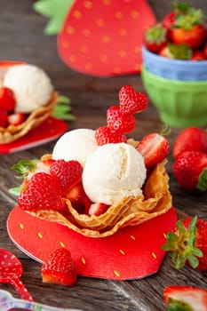 Vanilla ice cream with fresh strawberries in waffle cups