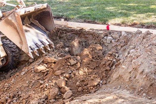 Small Bulldozer Digging In Yard For Pool Installation.