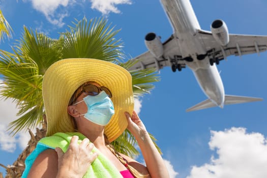 Girl With Towel, Hat, Sunglasses and Face Mask Under Palm Tree and Airplane..