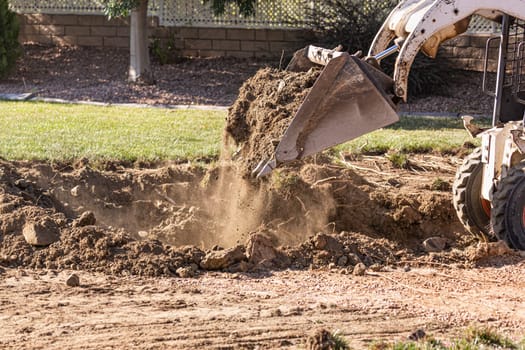 Small Bulldozer Digging In Yard For Pool Installation.