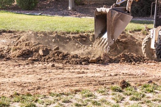 Small Bulldozer Digging In Yard For Pool Installation.