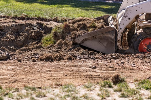 Small Bulldozer Digging In Yard For Pool Installation.