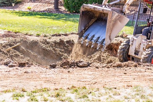 Small Bulldozer Digging In Yard For Pool Installation.