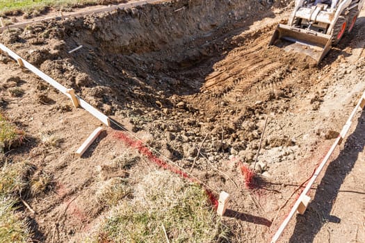 Small Bulldozer Digging In Yard For Pool Installation.