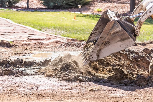 Small Bulldozer Digging In Yard For Pool Installation.