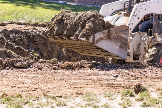 Small Bulldozer Digging In Yard For Pool Installation.