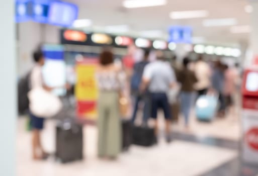Abstract blurred background of travelers at airport terminal departure check-in with bokeh light