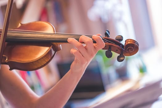 Young girl practices on her violin, acoustic music