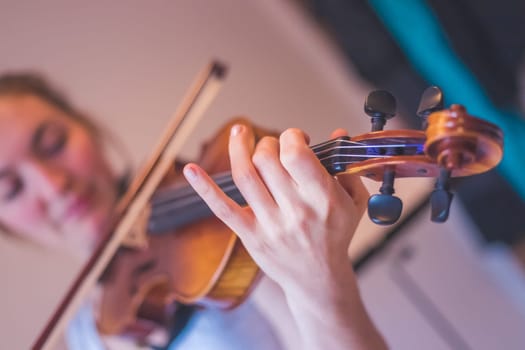 Young girl practices on her violin, acoustic music