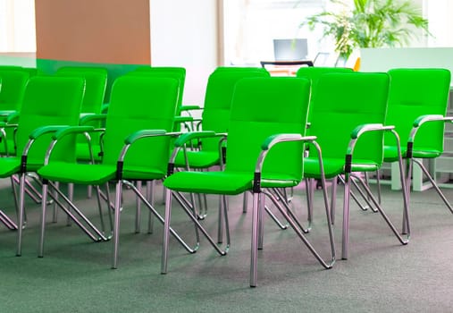 Therow of green office chairs in office. Selective focus