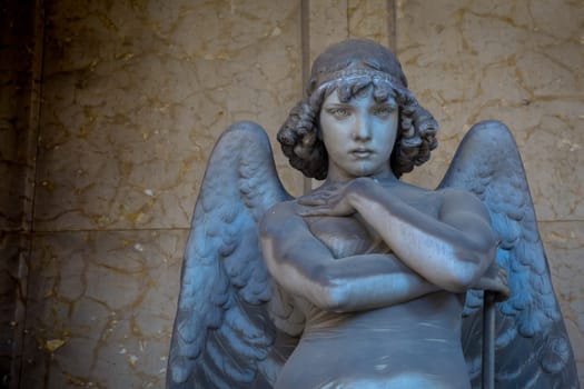 GENOA, ITALY - June 2020: antique statue of angel (beginning 1900, marble) in a Christian Catholic cemetery - Italy
