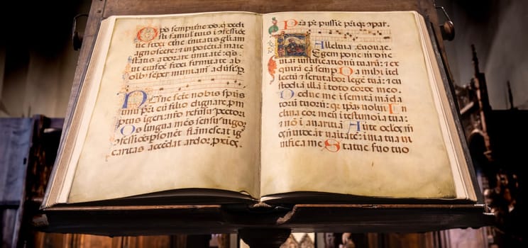 TURIN, ITALY - CIRCA MAY 2021: antique Medieval manuscript with ancient calligraphy.