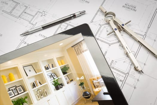 Computer Tablet with Finished Built-in Shelves and Cabinets Over House Plans, Pencil and Compass.