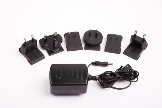 Power supply and international adaptor over bright background