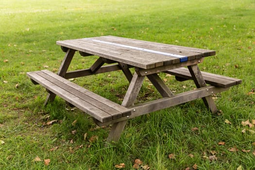 Outdoor bench with wooden table on a green meadow
