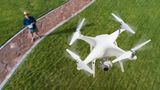 Drone Quadcopter (UAV) In Air Above Pilot With Remote Controller.
