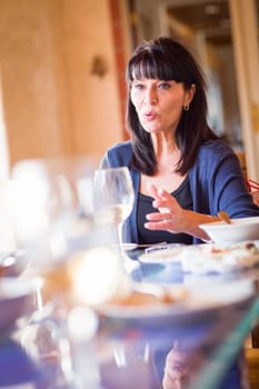 Pretty Italian Woman Enjoys A Meal And Drinks with Friends at Outdoor Restaurant.