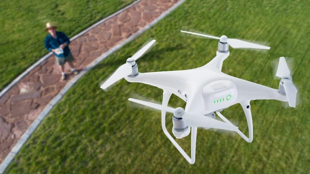 Drone Quadcopter (UAV) In Air Above Pilot With Remote Controller.